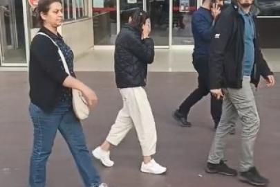 Yaşından büyük cezası olan kadın hırsız kameraları görünce yüzünü gizlemeye çalıştı