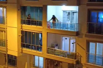 Sinir krizi geçiren genç kadın balkonundaki eşyaları yola fırlattı