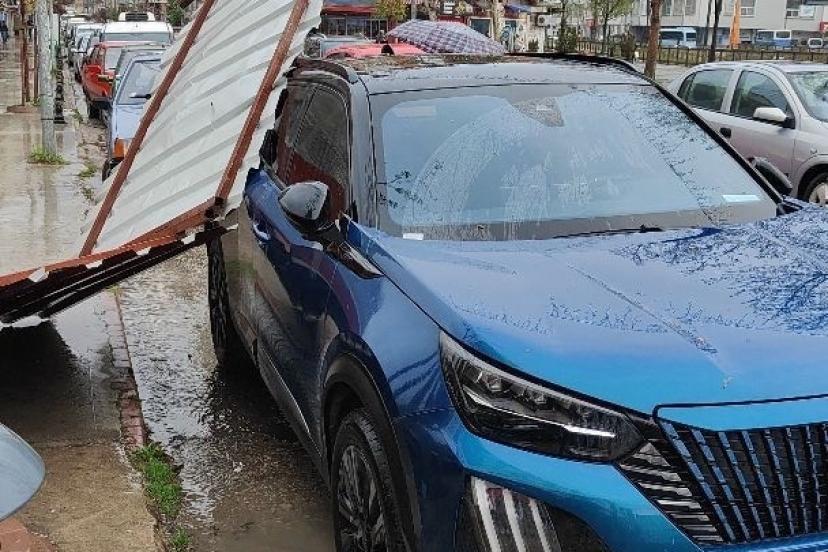 Fırtınanın etkisiyle yapıdan kopan parça araca zarar verdi