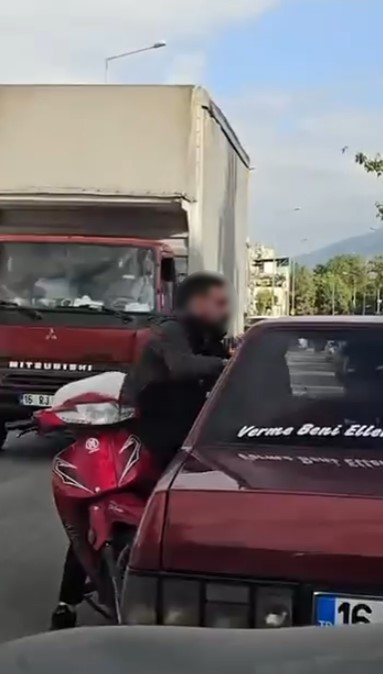 Otomobil sürücüsü dışarıya çıkmayınca motosikletli camdan içeri girmeye çalıştı